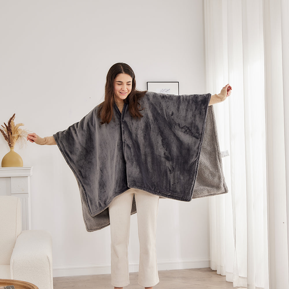 Une femme montre l'ampleur du poncho chauffant les bras écartés, vue de face